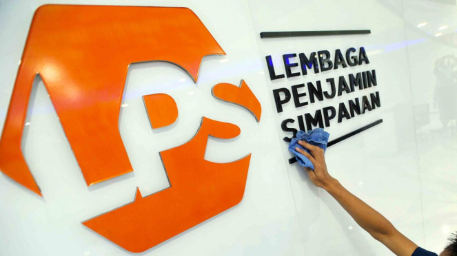 Karyawan membersihkan logo Lembaga Penjamin Simpanan (LPS) di Jakarta