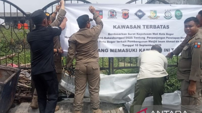 Satpol PP Kota Bogor memasang spanduk di gerbang Masjid Imam Ahmad bin Hanbal