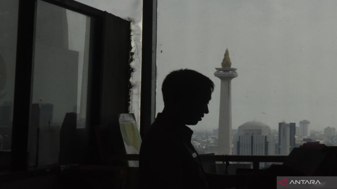 Siluet Aparatur Sipil Negara (ASN) dengan latar belakang Monas