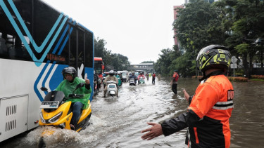 Petugas Dishub mengatur arus lalu lintas di tengah banjir DI Panjaitan Jaktim