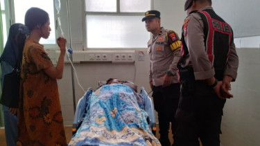 Petugas kepolisian menjenguk korban penyiraman cairn diduga air keras di Pacitan