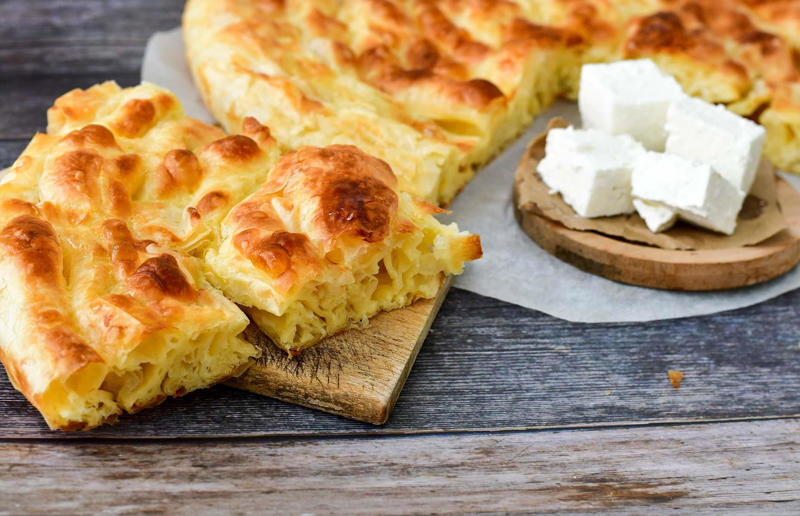 90. Peri peri chicken, Mozambique, 89. Sauerbraten, Germany, 88. Massaman, Thailand, 87. Spanakopita, Cyprus and Greece, 86. Cassoulet, France, 85. Banitsa, Bulgaria, 84. Barramundi, Australia, 83. Pastel de choclo, Chile, 82. Mole, Mexico, 81. Borscht, Ukraine, 80. Plov, Uzbekistan, 79. Bunny chow, South Africa, 78. Käsespätzle/ Käsknöpfle, Central Europe, 77. Chicken rice, Singapore, 76. Adobo, Philippines, 75. Rösti, Switzerland, 74. Falafel, Middle East, 73. Hoppers, Sri Lanka, 72. Nasi lemak, Malaysia, 71. Pupusa, El Salvador, 70. Beef rendang, Indonesia, 69. Tortilla de patatas, Spain, 68. French onion soup, France, 67. Colcannon, Ireland, 66. Bobotie, South Africa, 65. Haggis, Scotland, 64. Tamales, Central and South America, 63. Wiener schnitzel, Austria, 62. Feijoada, Brazil, 61. Souvlaki, Greece, 60. Laksa, Malaysia, 59. Clam chowder, USA, 58. Raclette, Switzerland, 57. Smørrebrød, Denmark, 56. Jollof rice, West Africa, 55. Poutine, Canada, 54. Goulash, Hungary, 53. Pho, Vietnam, 52. Biryani, India, 51. Arepa, Colombia and Venezuela, 50. Shawarma, Middle East, 49. Beef stroganoff, Russia, 48. Som tam, Laos, 47. Cacio e pepe, Italy, 46. Bouillabaisse, France, 45. Khachapuri, Georgia, 44. Ceviche, Peru, 43. Quesadilla, Mexico, 42. Masala dosa, India, 41. Moules frites, Belgium, 40. Köttbullar, Sweden, 39. Welsh rarebit, Wales, 38. Pierogi, Poland, 37. Poke, USA, 36. Tagine, Morocco, 35. Dim sum, China, 34. Gumbo, USA, 33. Kebab, Turkey, 32. Jerk chicken, Jamaica, 31. Singapore noodles, Hong Kong, 30. Asado, Argentina, 29. Beef Wellington, England, 28. Moussaka, Greece, 27. Tahdig, Iran, 26. Murgh makhani, India, 25. Gnocchi, Italy, 24. Sushi, Japan, 23. Texas-style barbecue, USA, 22. Fish and chips, UK, 21. Carbonara, Italy, 20. Tom yum soup, Thailand, 19. Cataplana, Portugal, 18. Mezze, Middle East, 17. Pad Thai, Thailand, 16. Steak frites, France, 15. Shakshuka, Middle East, 14. Tapas, Spain, 13. Gua bao, Taiwan, 12. Boeuf bourguignon, France, 11. Peking duck, China, 10. Chicken parmigiana, USA, 9. Bibimbap, South Korea, 8. Paella, Spain, 7. Tacos, Mexico, 6. Southern fried chicken, USA, 5. Sausage and mash, UK, 4. Ragù alla Bolognese, Italy, 3. Ramen, Japan, 2. Hamburger, USA