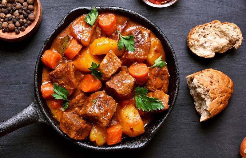 90. Peri peri chicken, Mozambique, 89. Sauerbraten, Germany, 88. Massaman, Thailand, 87. Spanakopita, Cyprus and Greece, 86. Cassoulet, France, 85. Banitsa, Bulgaria, 84. Barramundi, Australia, 83. Pastel de choclo, Chile, 82. Mole, Mexico, 81. Borscht, Ukraine, 80. Plov, Uzbekistan, 79. Bunny chow, South Africa, 78. Käsespätzle/ Käsknöpfle, Central Europe, 77. Chicken rice, Singapore, 76. Adobo, Philippines, 75. Rösti, Switzerland, 74. Falafel, Middle East, 73. Hoppers, Sri Lanka, 72. Nasi lemak, Malaysia, 71. Pupusa, El Salvador, 70. Beef rendang, Indonesia, 69. Tortilla de patatas, Spain, 68. French onion soup, France, 67. Colcannon, Ireland, 66. Bobotie, South Africa, 65. Haggis, Scotland, 64. Tamales, Central and South America, 63. Wiener schnitzel, Austria, 62. Feijoada, Brazil, 61. Souvlaki, Greece, 60. Laksa, Malaysia, 59. Clam chowder, USA, 58. Raclette, Switzerland, 57. Smørrebrød, Denmark, 56. Jollof rice, West Africa, 55. Poutine, Canada, 54. Goulash, Hungary, 53. Pho, Vietnam, 52. Biryani, India, 51. Arepa, Colombia and Venezuela, 50. Shawarma, Middle East, 49. Beef stroganoff, Russia, 48. Som tam, Laos, 47. Cacio e pepe, Italy, 46. Bouillabaisse, France, 45. Khachapuri, Georgia, 44. Ceviche, Peru, 43. Quesadilla, Mexico, 42. Masala dosa, India, 41. Moules frites, Belgium, 40. Köttbullar, Sweden, 39. Welsh rarebit, Wales, 38. Pierogi, Poland, 37. Poke, USA, 36. Tagine, Morocco, 35. Dim sum, China, 34. Gumbo, USA, 33. Kebab, Turkey, 32. Jerk chicken, Jamaica, 31. Singapore noodles, Hong Kong, 30. Asado, Argentina, 29. Beef Wellington, England, 28. Moussaka, Greece, 27. Tahdig, Iran, 26. Murgh makhani, India, 25. Gnocchi, Italy, 24. Sushi, Japan, 23. Texas-style barbecue, USA, 22. Fish and chips, UK, 21. Carbonara, Italy, 20. Tom yum soup, Thailand, 19. Cataplana, Portugal, 18. Mezze, Middle East, 17. Pad Thai, Thailand, 16. Steak frites, France, 15. Shakshuka, Middle East, 14. Tapas, Spain, 13. Gua bao, Taiwan, 12. Boeuf bourguignon, France, 11. Peking duck, China, 10. Chicken parmigiana, USA, 9. Bibimbap, South Korea, 8. Paella, Spain, 7. Tacos, Mexico, 6. Southern fried chicken, USA, 5. Sausage and mash, UK, 4. Ragù alla Bolognese, Italy, 3. Ramen, Japan, 2. Hamburger, USA