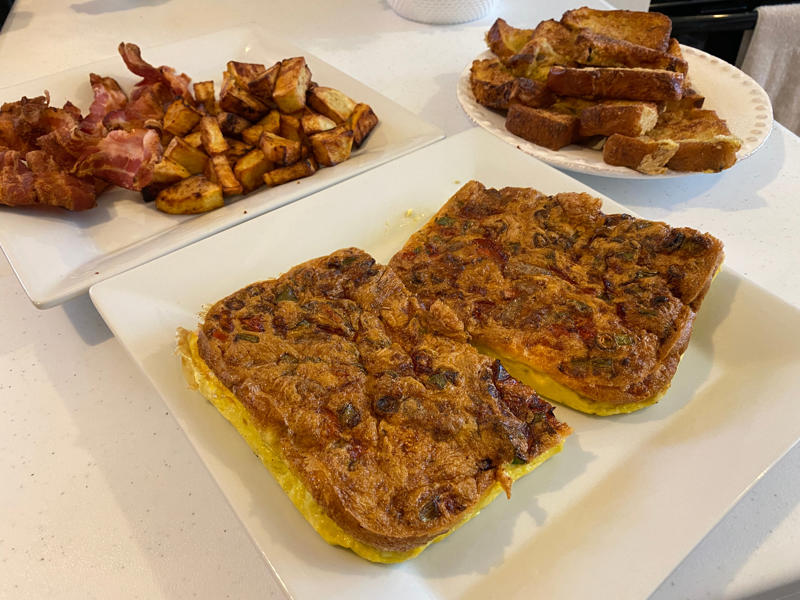 I started out with bacon, The bacon came out perfectly crispy, Next, I made breakfast potatoes, These home fries came out a little overcooked, For my 3rd recipe, I whipped up eggs in a basket, Next, I tried making an air-fryer frittata, For my final recipe, I attempted to make French toast, I barely had to add syrup for this recipe to taste good