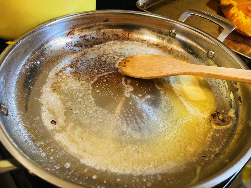 Next, I cooked the macaroni noodles., The recipe calls for a whopping 8 tablespoons of unsalted butter., I then added the hot milk into the flour-and-butter mixture., While the squash was roasting, I started cooking the onions.