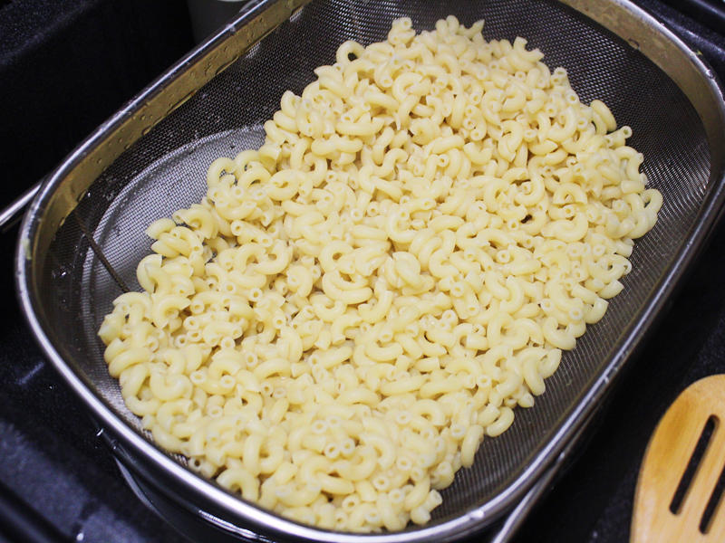 Next, I cooked the macaroni noodles., The recipe calls for a whopping 8 tablespoons of unsalted butter., I then added the hot milk into the flour-and-butter mixture., While the squash was roasting, I started cooking the onions.