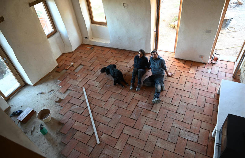 Laying the floors Meet the architects who transformed a 100-year-old ruin into a sustainable home, A meeting of minds, Shopping for a home, Rescuing a ruin, Crumbling but charming, Getting started, Seven garden terraces, Moving inside, Dismantling the roof, Remains of a ruin, Structural issues, Rebuilding the roof, Salvaging materials, Sealing the roof, Old meets new, Eco materials, Starting on the floors, Creating rooms, Insulation, insulation, insulation, Custom windows, Getting airtight, Plastering problems, Dressing the stone, Let there be light!, Laying the floors, Creating a cosy living room, A welcoming living space, Perfect for entertaining, DIY kitchen, An eco-conscious cooking spot, Polished bathroom walls, Ready for a spa session, A reclaimed patio, Breathtaking backyard views, Olives and lavender