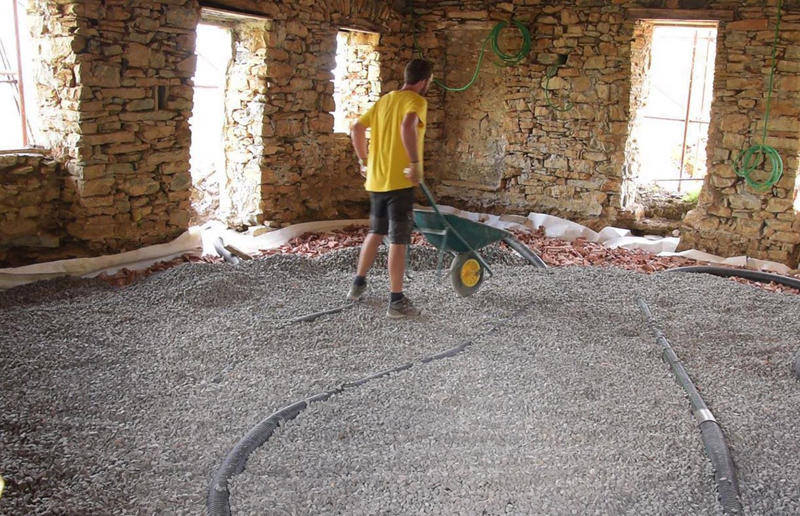 Starting on the floors Meet the architects who transformed a 100-year-old ruin into a sustainable home, A meeting of minds, Shopping for a home, Rescuing a ruin, Crumbling but charming, Getting started, Seven garden terraces, Moving inside, Dismantling the roof, Remains of a ruin, Structural issues, Rebuilding the roof, Salvaging materials, Sealing the roof, Old meets new, Eco materials, Starting on the floors, Creating rooms, Insulation, insulation, insulation, Custom windows, Getting airtight, Plastering problems, Dressing the stone, Let there be light!, Laying the floors, Creating a cosy living room, A welcoming living space, Perfect for entertaining, DIY kitchen, An eco-conscious cooking spot, Polished bathroom walls, Ready for a spa session, A reclaimed patio, Breathtaking backyard views, Olives and lavender