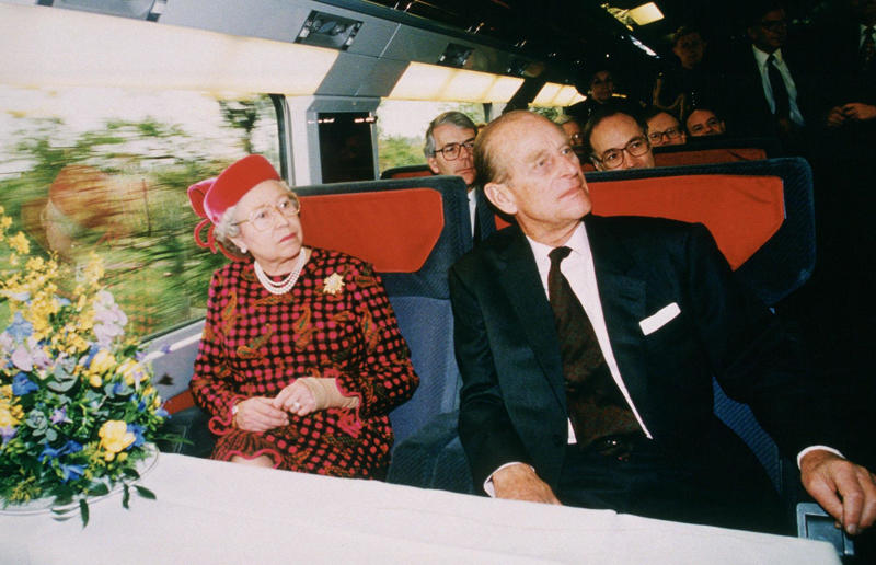 1990s: The late Queen Elizabeth II and Prince Philip aboard Eurostar Rail travel through the ages, 1860s: Royals embrace train travel, 1870s: An early railroad bridge in Arizona, 1880s: Luxurious interior of a railroad car, 1880s: First transcontinental train in Canada, 1890s: Dining car on the Chicago Great Western Limited, 1890s: Barber shop on board a train, 1900s: All about comfort, 1910s: Royals on tour, 1910s: Train travel for everyone, 1910s: Darjeeling Himalayan Railway loop, 1920s: First non-stop service of the Flying Scotsman, 1920s: Swedish State Railways Second Class, 1920s: New entertainment on board, 1930s: Films on trains, 1920s: Holiday rush, 1930s: Sleeping in comfort, 1930s: Battling baggage, 1930s: Summer holidays in the Austrian countryside, 1940s: Long-haul journeys in comfort, 1940s: New luxury trains, 1950s: Lounge on the Southern Pacific Sunset Limited, 1960s: A dream of Eurotunnel, 1960s: High-speed rail travel is unveiled in Japan, 1970s: Dome car of the Southwest Limited, 1970s: The inaugural journey of the Indian Pacific, 1970s: Final journey of the Orient Express, 1980s: Business on the go, 1990s: Passengers en route to the Royal Ascot, 1990s: The late Queen Elizabeth II and Prince Philip aboard Eurostar, 2000s: Amtrak employees in front of the new Acela Express train, 2000s: Aboard the American Orient Express, 2010s: High-speed train travel in China