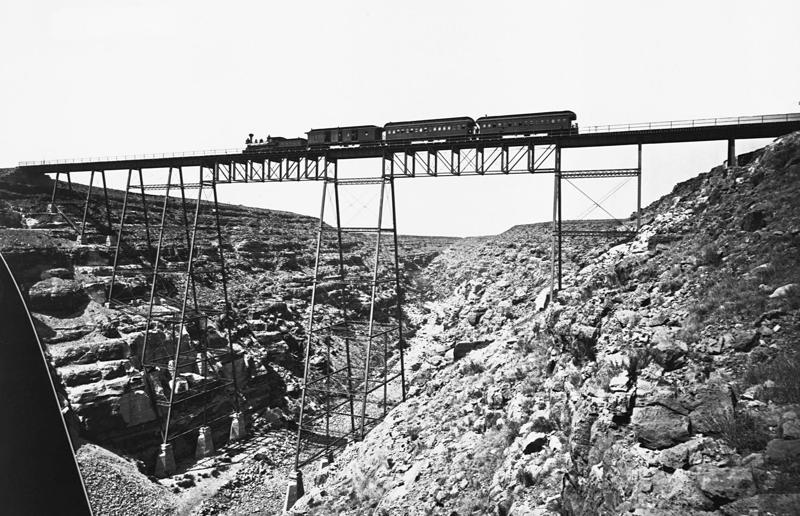 1870s: an early railroad bridge in Arizona Rail travel through the ages, 1860s: Royals embrace train travel, 1870s: An early railroad bridge in Arizona, 1880s: Luxurious interior of a railroad car, 1880s: First transcontinental train in Canada, 1890s: Dining car on the Chicago Great Western Limited, 1890s: Barber shop on board a train, 1900s: All about comfort, 1910s: Royals on tour, 1910s: Train travel for everyone, 1910s: Darjeeling Himalayan Railway loop, 1920s: First non-stop service of the Flying Scotsman, 1920s: Swedish State Railways Second Class, 1920s: New entertainment on board, 1930s: Films on trains, 1920s: Holiday rush, 1930s: Sleeping in comfort, 1930s: Battling baggage, 1930s: Summer holidays in the Austrian countryside, 1940s: Long-haul journeys in comfort, 1940s: New luxury trains, 1950s: Lounge on the Southern Pacific Sunset Limited, 1960s: A dream of Eurotunnel, 1960s: High-speed rail travel is unveiled in Japan, 1970s: Dome car of the Southwest Limited, 1970s: The inaugural journey of the Indian Pacific, 1970s: Final journey of the Orient Express, 1980s: Business on the go, 1990s: Passengers en route to the Royal Ascot, 1990s: The late Queen Elizabeth II and Prince Philip aboard Eurostar, 2000s: Amtrak employees in front of the new Acela Express train, 2000s: Aboard the American Orient Express, 2010s: High-speed train travel in China