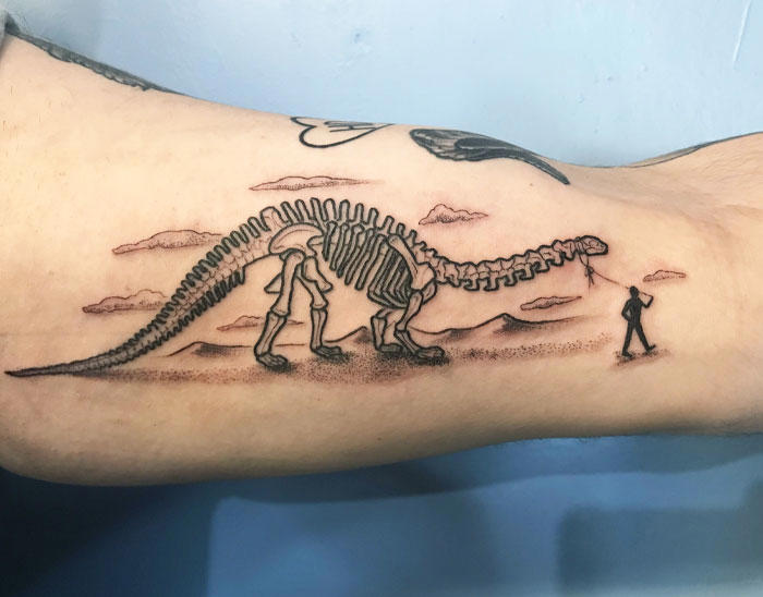 #1 Very Colorful Dinosaur, #2 White Stegosaurus Fossil, #4 A Blind Cat Walking His Guiding Velociraptor, #6 Dinosaur Bubble Bath, #7 Dinosaur Sleeve, #8 Gorgeous Work, #9 My Favorite, #10 Ok Google, #11 Furry Little Dinosaur, #12 Super Cute Dino, #13 Siblings' Tattoos, #14 Does Everyone Like Geometric Art? T-Rex Skull, #16 Tattoo Museum, #18 Jungle Dinosaur, #19 Origami T-Rex, #20 My Cartoon Dinosaurs' Tattoo, #21 Dino With Underwater Scene, #22 I Bet This Tea Comes With A Very Special Flavor, #23 Hand-Poked Dinosaur, #24 Yehaaaw, #25 Punk Raptor, #26 Dinos Love Donuts, #27 First Tattoo, #28 Basquiat Dino, #29 We All Live In A Submarine, #30 Raptor. Really Amazing Work, #31 T-Rex Skeleton, #32 Aliens vs. Dinosaurs, #33 T-Rex, #35 Dinosaur Tattoo For Gamers, #37 Uncle Brachiosaurus With His Nephew, #38 Velociraptor, #39 This T-Rex Done By Me, #40 This Guy Is My Neighbor, #41 Dinosaur Sleeve, #42 Walking A T-Rex, #43 Color Realism Velociraptor. Work In Progress, #44 Dinosaur And A Warrior, #46 Just A Man And His Dino