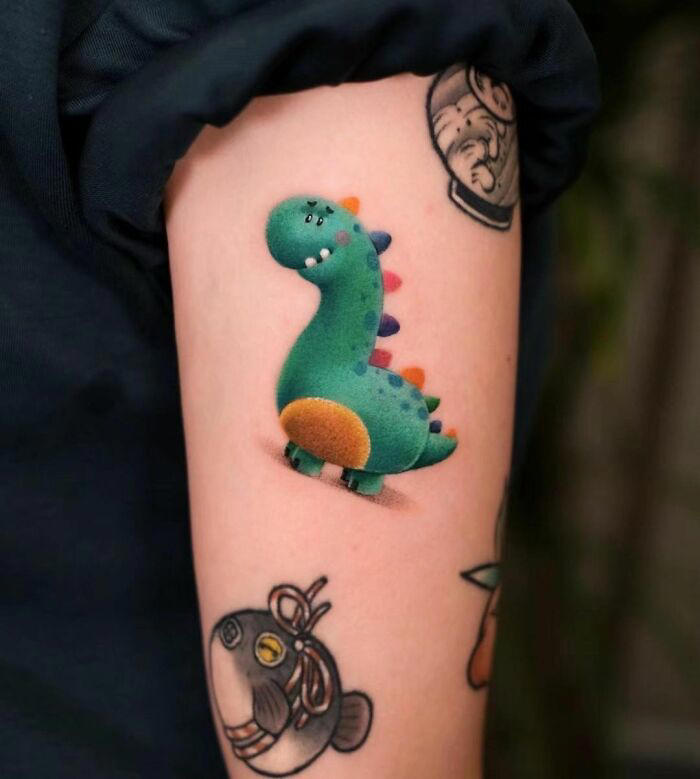 #11 Furry Little Dinosaur #1 Very Colorful Dinosaur, #2 White Stegosaurus Fossil, #4 A Blind Cat Walking His Guiding Velociraptor, #6 Dinosaur Bubble Bath, #7 Dinosaur Sleeve, #8 Gorgeous Work, #9 My Favorite, #10 Ok Google, #11 Furry Little Dinosaur, #12 Super Cute Dino, #13 Siblings' Tattoos, #14 Does Everyone Like Geometric Art? T-Rex Skull, #16 Tattoo Museum, #18 Jungle Dinosaur, #19 Origami T-Rex, #20 My Cartoon Dinosaurs' Tattoo, #21 Dino With Underwater Scene, #22 I Bet This Tea Comes With A Very Special Flavor, #23 Hand-Poked Dinosaur, #24 Yehaaaw, #25 Punk Raptor, #26 Dinos Love Donuts, #27 First Tattoo, #28 Basquiat Dino, #29 We All Live In A Submarine, #30 Raptor. Really Amazing Work, #31 T-Rex Skeleton, #32 Aliens vs. Dinosaurs, #33 T-Rex, #35 Dinosaur Tattoo For Gamers, #37 Uncle Brachiosaurus With His Nephew, #38 Velociraptor, #39 This T-Rex Done By Me, #40 This Guy Is My Neighbor, #41 Dinosaur Sleeve, #42 Walking A T-Rex, #43 Color Realism Velociraptor. Work In Progress, #44 Dinosaur And A Warrior, #46 Just A Man And His Dino