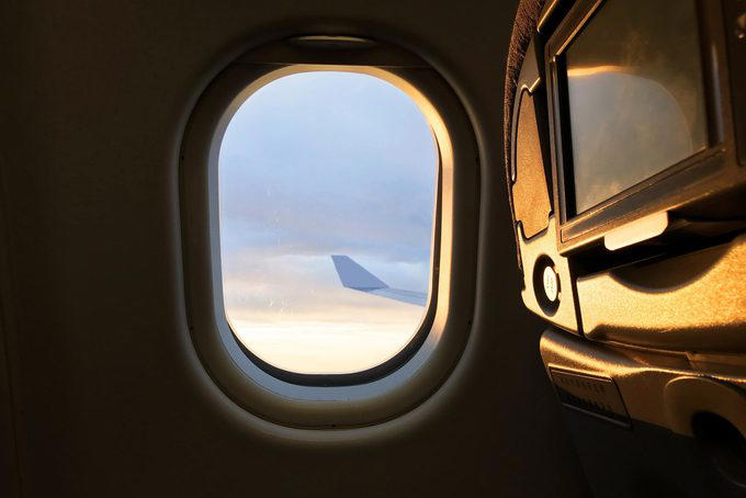 Book a window seat if you’re flying economy, Bring sleep accessories, especially if you have a middle seat, Take a power nap, Prioritize sleep before a long-haul flight, Limit your use of electronics, Skip the alcohol and caffeine, Bring a light-blocking eye mask, Stick to your bedtime routine, Opt out of the in-flight meal, Consider a sleep aid, About the experts, Why trust us