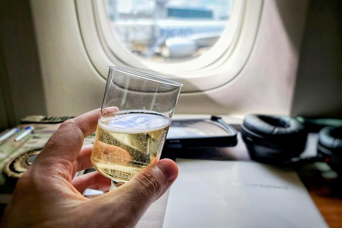 Book a window seat if you’re flying economy, Bring sleep accessories, especially if you have a middle seat, Take a power nap, Prioritize sleep before a long-haul flight, Limit your use of electronics, Skip the alcohol and caffeine, Bring a light-blocking eye mask, Stick to your bedtime routine, Opt out of the in-flight meal, Consider a sleep aid, About the experts, Why trust us
