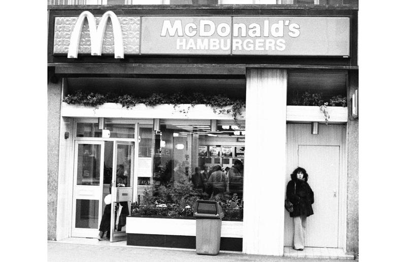 A change in (exterior) pace In pictures: McDonald's in the 1980s, Old-school signage, Differing styles, A move towards simpler signs, A slice of history, Golden exterior, The same, but different, Striking appearances, The rise of the drive-thru, A change in (exterior) pace, City branches, Outdoor space aplenty, Endless fun for kids, A place to hang out, Busy preparation areas, Recycling systems, Menu highlights, Item checklist, The Chicken McNuggets phenomenon, Coupon craze, McDonald’s in Tokyo, Japan, Menus in Tokyo, Japan, Global openings, Colourful uniforms, Service with a smile, Mascots were everywhere, A push for evening meals, Royal window displays, Esteemed guests, Presidential visits