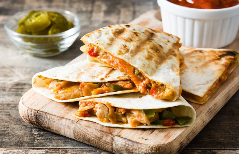 90. Peri peri chicken, Mozambique, 89. Sauerbraten, Germany, 88. Massaman, Thailand, 87. Spanakopita, Cyprus and Greece, 86. Cassoulet, France, 85. Banitsa, Bulgaria, 84. Barramundi, Australia, 83. Pastel de choclo, Chile, 82. Mole, Mexico, 81. Borscht, Ukraine, 80. Plov, Uzbekistan, 79. Bunny chow, South Africa, 78. Käsespätzle/ Käsknöpfle, Central Europe, 77. Chicken rice, Singapore, 76. Adobo, Philippines, 75. Rösti, Switzerland, 74. Falafel, Middle East, 73. Hoppers, Sri Lanka, 72. Nasi lemak, Malaysia, 71. Pupusa, El Salvador, 70. Beef rendang, Indonesia, 69. Tortilla de patatas, Spain, 68. French onion soup, France, 67. Colcannon, Ireland, 66. Bobotie, South Africa, 65. Haggis, Scotland, 64. Tamales, Central and South America, 63. Wiener schnitzel, Austria, 62. Feijoada, Brazil, 61. Souvlaki, Greece, 60. Laksa, Malaysia, 59. Clam chowder, USA, 58. Raclette, Switzerland, 57. Smørrebrød, Denmark, 56. Jollof rice, West Africa, 55. Poutine, Canada, 54. Goulash, Hungary, 53. Pho, Vietnam, 52. Biryani, India, 51. Arepa, Colombia and Venezuela, 50. Shawarma, Middle East, 49. Beef stroganoff, Russia, 48. Som tam, Laos, 47. Cacio e pepe, Italy, 46. Bouillabaisse, France, 45. Khachapuri, Georgia, 44. Ceviche, Peru, 43. Quesadilla, Mexico, 42. Masala dosa, India, 41. Moules frites, Belgium, 40. Köttbullar, Sweden, 39. Welsh rarebit, Wales, 38. Pierogi, Poland, 37. Poke, USA, 36. Tagine, Morocco, 35. Dim sum, China, 34. Gumbo, USA, 33. Kebab, Turkey, 32. Jerk chicken, Jamaica, 31. Singapore noodles, Hong Kong, 30. Asado, Argentina, 29. Beef Wellington, England, 28. Moussaka, Greece, 27. Tahdig, Iran, 26. Murgh makhani, India, 25. Gnocchi, Italy, 24. Sushi, Japan, 23. Texas-style barbecue, USA, 22. Fish and chips, UK, 21. Carbonara, Italy, 20. Tom yum soup, Thailand, 19. Cataplana, Portugal, 18. Mezze, Middle East, 17. Pad Thai, Thailand, 16. Steak frites, France, 15. Shakshuka, Middle East, 14. Tapas, Spain, 13. Gua bao, Taiwan, 12. Boeuf bourguignon, France, 11. Peking duck, China, 10. Chicken parmigiana, USA, 9. Bibimbap, South Korea, 8. Paella, Spain, 7. Tacos, Mexico, 6. Southern fried chicken, USA, 5. Sausage and mash, UK, 4. Ragù alla Bolognese, Italy, 3. Ramen, Japan, 2. Hamburger, USA