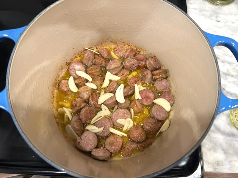 After cooking the sausages for five minutes, I added the garlic. Ina Garten's orecchiette pasta features two types of sausage and broccoli rabe., First, I preheated the oven to 350 degrees Fahrenheit and prepped the sausages., After cooking the sausages for five minutes, I added the garlic., Then, it was time to add the tomatoes and wine.
