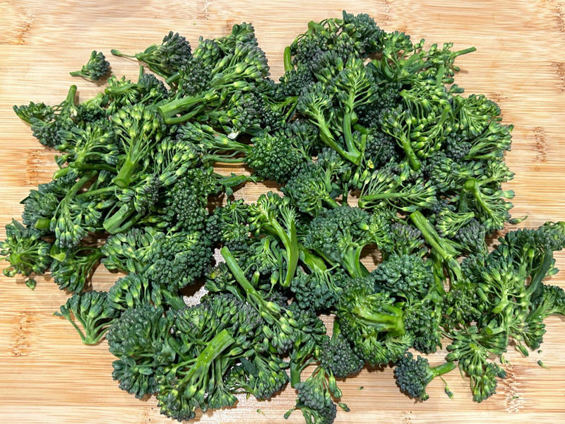 I set a timer for exactly nine minutes and prepped the broccoli as my pasta cooked. Ina Garten's orecchiette pasta features two types of sausage and broccoli rabe., First, I preheated the oven to 350 degrees Fahrenheit and prepped the sausages., After cooking the sausages for five minutes, I added the garlic., Then, it was time to add the tomatoes and wine.
