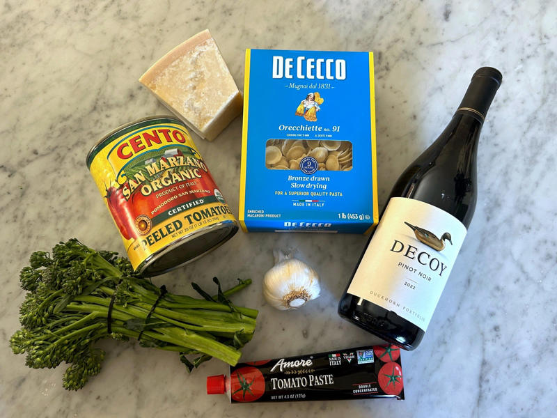 Ina Garten's orecchiette pasta features two types of sausage and broccoli rabe. Ina Garten's orecchiette pasta features two types of sausage and broccoli rabe., First, I preheated the oven to 350 degrees Fahrenheit and prepped the sausages., After cooking the sausages for five minutes, I added the garlic., Then, it was time to add the tomatoes and wine.