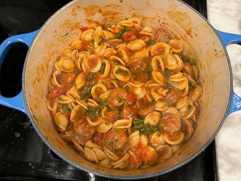 Then, I added the pasta and broccoli to the pot with the sausage and tomato sauce. Ina Garten's orecchiette pasta features two types of sausage and broccoli rabe., First, I preheated the oven to 350 degrees Fahrenheit and prepped the sausages., After cooking the sausages for five minutes, I added the garlic., Then, it was time to add the tomatoes and wine.