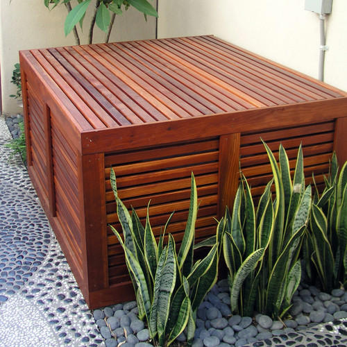 Hide AC Unit with a Living Garden AC Cover, Hide AC Unit with a Modern Outdoor AC Cover, AC Cover/Tool Shed, Hide AC Unit with Tall Shrubs, Hide AC Unit with Birdhouse Picket Fence, Hide AC Unit with a Shabby Chic Shutter Screen, Hide AC Unit with an Iron Trellis, Hide AC Unit with a Multi-Purpose Structure, Hide AC Unit with an Outdoor Privacy Screen