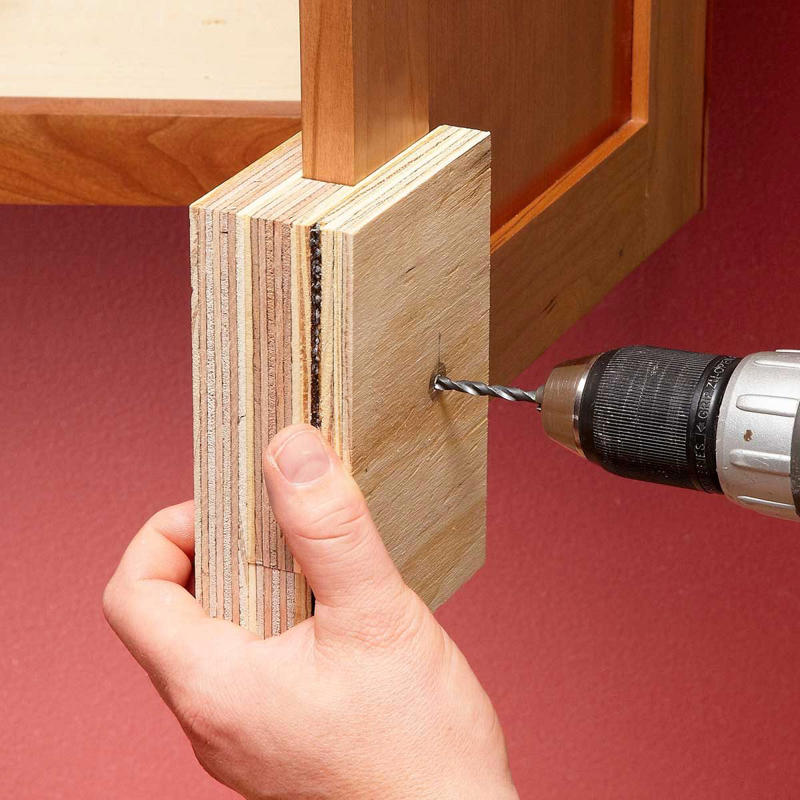 Two-Sided Templates Prevent Tear-Out 13 Tips To Install Cabinet Hardware Perfectly Every Time Gettyimages 1389698183 Ft, Use the Door Rail as a Guide, Hide Old Holes With Back Plates, Make a Simple Drawer Template, Two-Sided Templates Prevent Tear-Out, Use Thread Sealant to Keep the Screws Tight, Mix Putty to Match, Install Hardware Higher on the Lowest Drawer, Perfect Finish Touch-Ups
