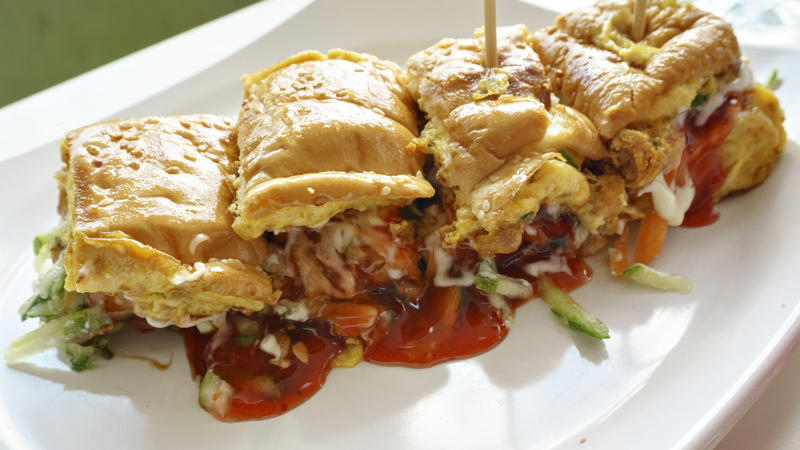 Roti john, Malaysia/Singapore Vegemite, Australia, Yakisoba-pan, Japan, Roti john, Malaysia/Singapore, Vada pav, India, Breakfast roll, Ireland, Kaya toast, Singapore, Francesinha, Portugal, Bocadillo, Spain, Zapiekanka, Poland, Katsu sando, Japan, Cemita, Mexico, Bauru, Brazil, Rarebit, Wales, Leberkäsesemmel, Germany, Bánh mì, Vietnam, Jambon-beurre, France, Falafel, across the Middle East, Arepa, Venezuela, Montreal-style smoked meat, Canada, Pork chop bun, Macau, Tripleta, Puerto Rico, Chivito, Uruguay, Medianoche, Cuba, Chopped barbecue, USA, Gyro, Greece