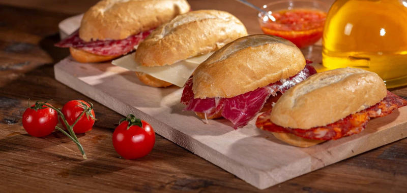 Bocadillo, Spain Vegemite, Australia, Yakisoba-pan, Japan, Roti john, Malaysia/Singapore, Vada pav, India, Breakfast roll, Ireland, Kaya toast, Singapore, Francesinha, Portugal, Bocadillo, Spain, Zapiekanka, Poland, Katsu sando, Japan, Cemita, Mexico, Bauru, Brazil, Rarebit, Wales, Leberkäsesemmel, Germany, Bánh mì, Vietnam, Jambon-beurre, France, Falafel, across the Middle East, Arepa, Venezuela, Montreal-style smoked meat, Canada, Pork chop bun, Macau, Tripleta, Puerto Rico, Chivito, Uruguay, Medianoche, Cuba, Chopped barbecue, USA, Gyro, Greece