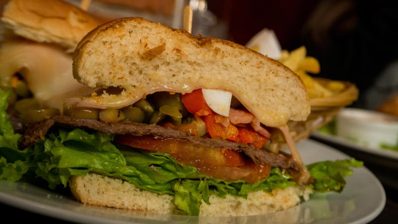 Chivito, Uruguay Vegemite, Australia, Yakisoba-pan, Japan, Roti john, Malaysia/Singapore, Vada pav, India, Breakfast roll, Ireland, Kaya toast, Singapore, Francesinha, Portugal, Bocadillo, Spain, Zapiekanka, Poland, Katsu sando, Japan, Cemita, Mexico, Bauru, Brazil, Rarebit, Wales, Leberkäsesemmel, Germany, Bánh mì, Vietnam, Jambon-beurre, France, Falafel, across the Middle East, Arepa, Venezuela, Montreal-style smoked meat, Canada, Pork chop bun, Macau, Tripleta, Puerto Rico, Chivito, Uruguay, Medianoche, Cuba, Chopped barbecue, USA, Gyro, Greece