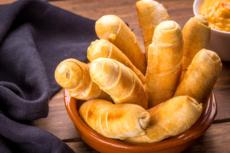 Tequeños, Venezuela Fish and chips, England, Tequeños, Venezuela, Spanish tortilla, Spain, Gyros, Greece, Spring rolls, China, Falafel, Egypt, Cordon bleu, Switzerland, Chivito, Uruguay, Samosa, India, Boxty, Ireland, Pirozhki, Russia, Bobotie, South Africa, Tostones, Dominican Republic, Choripán, Argentina, Grilled sardines, Portugal, Rice and beans, Brazil