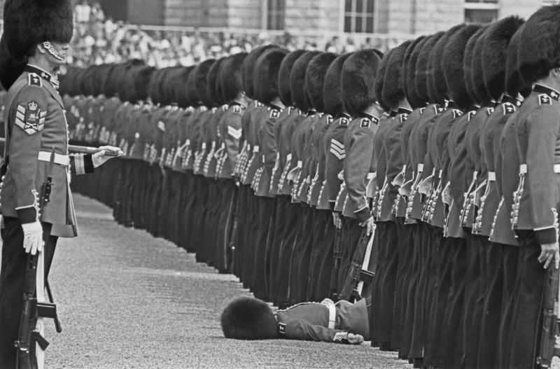 They may faint They’re part of British history, They need to be tall, They need to pass an exam, They go through a demanding training program, Remuneration package, They are early birds, They have to be resilient, Their hats are old, big, and heavy, They wear their hats in a peculiar way, Their uniforms must be in top-notch condition at all times, They may faint, Hot weather can be a nightmare, They can still serve their country in military operations, They might chat with members of the royal family