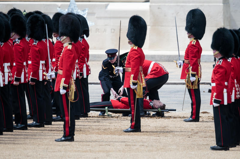 They may faint They’re part of British history, They need to be tall, They need to pass an exam, They go through a demanding training program, Remuneration package, They are early birds, They have to be resilient, Their hats are old, big, and heavy, They wear their hats in a peculiar way, Their uniforms must be in top-notch condition at all times, They may faint, Hot weather can be a nightmare, They can still serve their country in military operations, They might chat with members of the royal family
