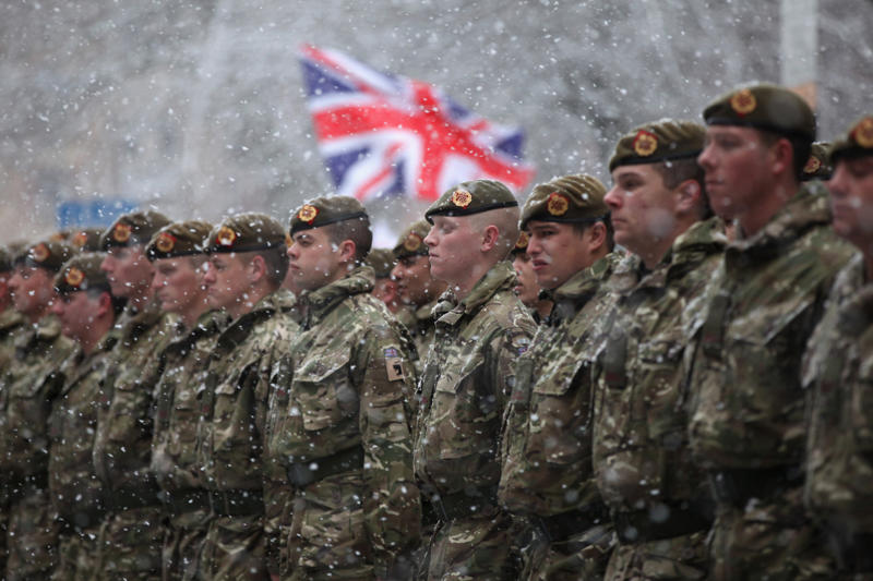 They can still serve their country in military operations They’re part of British history, They need to be tall, They need to pass an exam, They go through a demanding training program, Remuneration package, They are early birds, They have to be resilient, Their hats are old, big, and heavy, They wear their hats in a peculiar way, Their uniforms must be in top-notch condition at all times, They may faint, Hot weather can be a nightmare, They can still serve their country in military operations, They might chat with members of the royal family