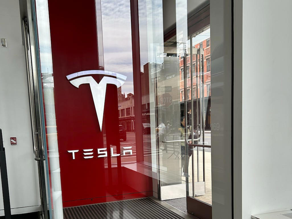 The first thing I noticed was a cleaning staff dusting off surfaces and cleaning the space. It had two EVs featured in the store., Rivian had Boxed Water in a basket at the door., The decor was colorful, outdoorsy, and relaxed., A Rivian spokesperson told me that the store is designed for families., The store had a merchandise section with locally sourced reusable bags, A Rivian employee took me on a test drive., I didn't see too many customers during my visit., I went to Tesla's showroom in the Meatpacking District the next day., The store's design was tech-forward, sleek, and futuristic., Tesla had some interactive elements in the space., The wall posters were more show than tell., The space also showed off Tesla's tech., Tesla's Optimus humanoid robot was on display., The staff seemed used to tourists popping in and taking photos., I was offered an espresso while I waited for my test ride., To sum it up: I enjoyed both experiences.