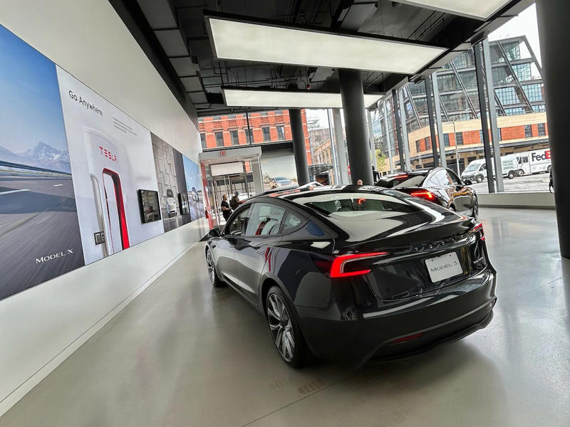 The store's design was tech-forward, sleek, and futuristic. It had two EVs featured in the store., Rivian had Boxed Water in a basket at the door., The decor was colorful, outdoorsy, and relaxed., A Rivian spokesperson told me that the store is designed for families., The store had a merchandise section with locally sourced reusable bags, A Rivian employee took me on a test drive., I didn't see too many customers during my visit., I went to Tesla's showroom in the Meatpacking District the next day., The store's design was tech-forward, sleek, and futuristic., Tesla had some interactive elements in the space., The wall posters were more show than tell., The space also showed off Tesla's tech., Tesla's Optimus humanoid robot was on display., The staff seemed used to tourists popping in and taking photos., I was offered an espresso while I waited for my test ride., To sum it up: I enjoyed both experiences.