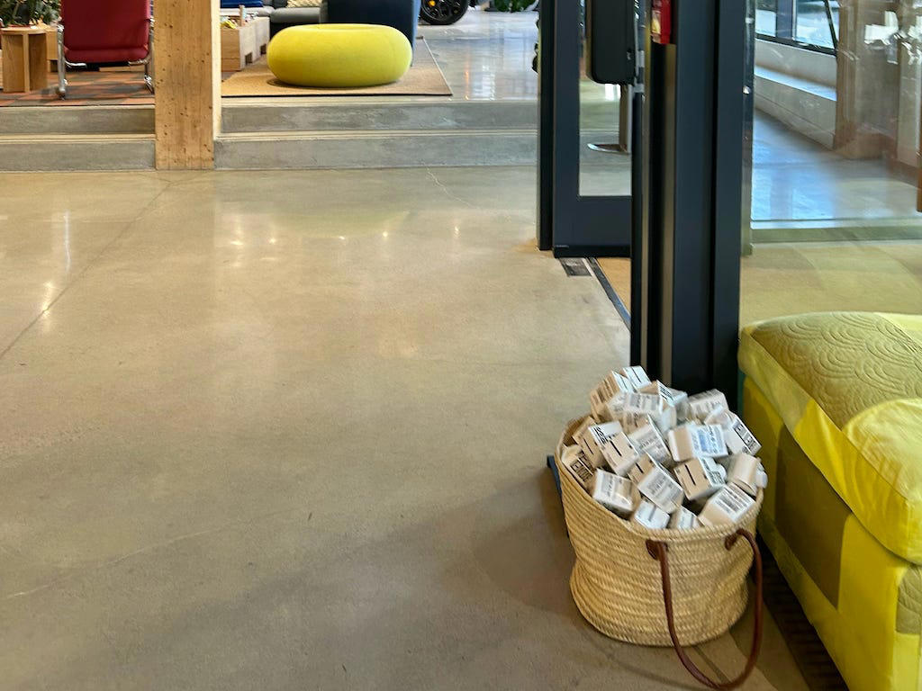 Rivian had Boxed Water in a basket at the door. It had two EVs featured in the store., Rivian had Boxed Water in a basket at the door., The decor was colorful, outdoorsy, and relaxed., A Rivian spokesperson told me that the store is designed for families., The store had a merchandise section with locally sourced reusable bags, A Rivian employee took me on a test drive., I didn't see too many customers during my visit., I went to Tesla's showroom in the Meatpacking District the next day., The store's design was tech-forward, sleek, and futuristic., Tesla had some interactive elements in the space., The wall posters were more show than tell., The space also showed off Tesla's tech., Tesla's Optimus humanoid robot was on display., The staff seemed used to tourists popping in and taking photos., I was offered an espresso while I waited for my test ride., To sum it up: I enjoyed both experiences.