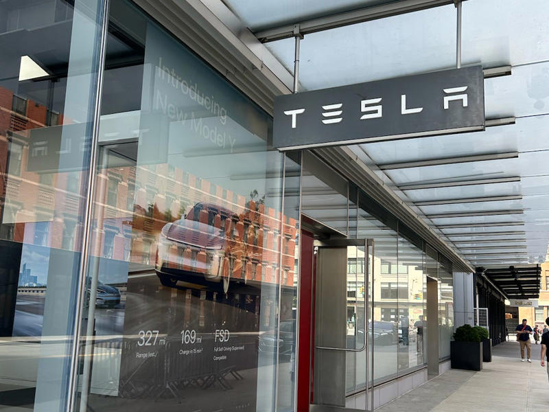 I went to Tesla's showroom in the Meatpacking District the next day. It had two EVs featured in the store., Rivian had Boxed Water in a basket at the door., The decor was colorful, outdoorsy, and relaxed., A Rivian spokesperson told me that the store is designed for families., The store had a merchandise section with locally sourced reusable bags, A Rivian employee took me on a test drive., I didn't see too many customers during my visit., I went to Tesla's showroom in the Meatpacking District the next day., The store's design was tech-forward, sleek, and futuristic., Tesla had some interactive elements in the space., The wall posters were more show than tell., The space also showed off Tesla's tech., Tesla's Optimus humanoid robot was on display., The staff seemed used to tourists popping in and taking photos., I was offered an espresso while I waited for my test ride., To sum it up: I enjoyed both experiences.