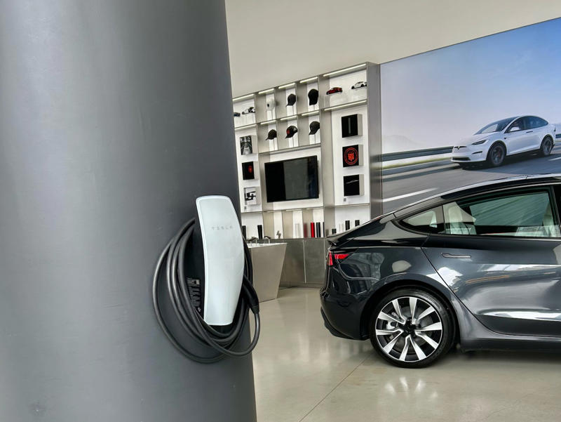 Tesla had some interactive elements in the space. It had two EVs featured in the store., Rivian had Boxed Water in a basket at the door., The decor was colorful, outdoorsy, and relaxed., A Rivian spokesperson told me that the store is designed for families., The store had a merchandise section with locally sourced reusable bags, A Rivian employee took me on a test drive., I didn't see too many customers during my visit., I went to Tesla's showroom in the Meatpacking District the next day., The store's design was tech-forward, sleek, and futuristic., Tesla had some interactive elements in the space., The wall posters were more show than tell., The space also showed off Tesla's tech., Tesla's Optimus humanoid robot was on display., The staff seemed used to tourists popping in and taking photos., I was offered an espresso while I waited for my test ride., To sum it up: I enjoyed both experiences.