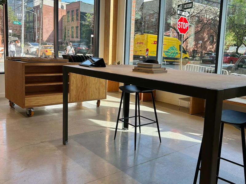 I didn't see too many customers during my visit. It had two EVs featured in the store., Rivian had Boxed Water in a basket at the door., The decor was colorful, outdoorsy, and relaxed., A Rivian spokesperson told me that the store is designed for families., The store had a merchandise section with locally sourced reusable bags, A Rivian employee took me on a test drive., I didn't see too many customers during my visit., I went to Tesla's showroom in the Meatpacking District the next day., The store's design was tech-forward, sleek, and futuristic., Tesla had some interactive elements in the space., The wall posters were more show than tell., The space also showed off Tesla's tech., Tesla's Optimus humanoid robot was on display., The staff seemed used to tourists popping in and taking photos., I was offered an espresso while I waited for my test ride., To sum it up: I enjoyed both experiences.