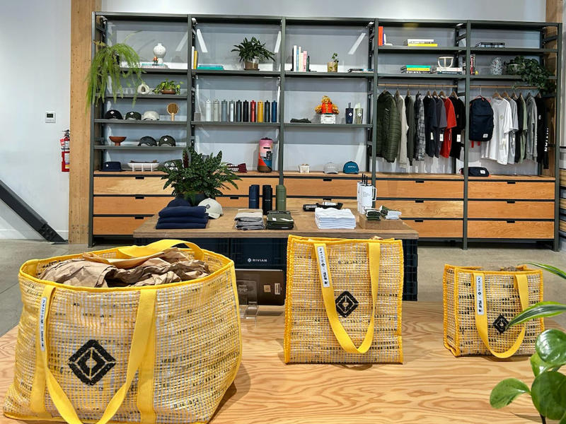 The store had a merchandise section with locally sourced reusable bags It had two EVs featured in the store., Rivian had Boxed Water in a basket at the door., The decor was colorful, outdoorsy, and relaxed., A Rivian spokesperson told me that the store is designed for families., The store had a merchandise section with locally sourced reusable bags, A Rivian employee took me on a test drive., I didn't see too many customers during my visit., I went to Tesla's showroom in the Meatpacking District the next day., The store's design was tech-forward, sleek, and futuristic., Tesla had some interactive elements in the space., The wall posters were more show than tell., The space also showed off Tesla's tech., Tesla's Optimus humanoid robot was on display., The staff seemed used to tourists popping in and taking photos., I was offered an espresso while I waited for my test ride., To sum it up: I enjoyed both experiences.