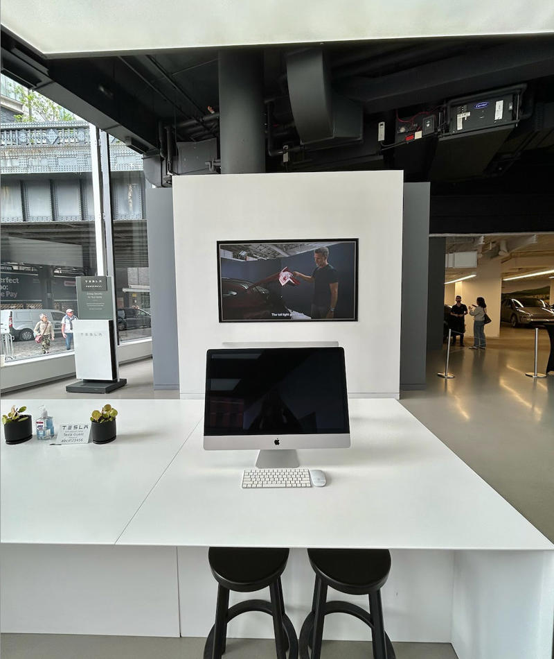 I was offered an espresso while I waited for my test ride. It had two EVs featured in the store., Rivian had Boxed Water in a basket at the door., The decor was colorful, outdoorsy, and relaxed., A Rivian spokesperson told me that the store is designed for families., The store had a merchandise section with locally sourced reusable bags, A Rivian employee took me on a test drive., I didn't see too many customers during my visit., I went to Tesla's showroom in the Meatpacking District the next day., The store's design was tech-forward, sleek, and futuristic., Tesla had some interactive elements in the space., The wall posters were more show than tell., The space also showed off Tesla's tech., Tesla's Optimus humanoid robot was on display., The staff seemed used to tourists popping in and taking photos., I was offered an espresso while I waited for my test ride., To sum it up: I enjoyed both experiences.