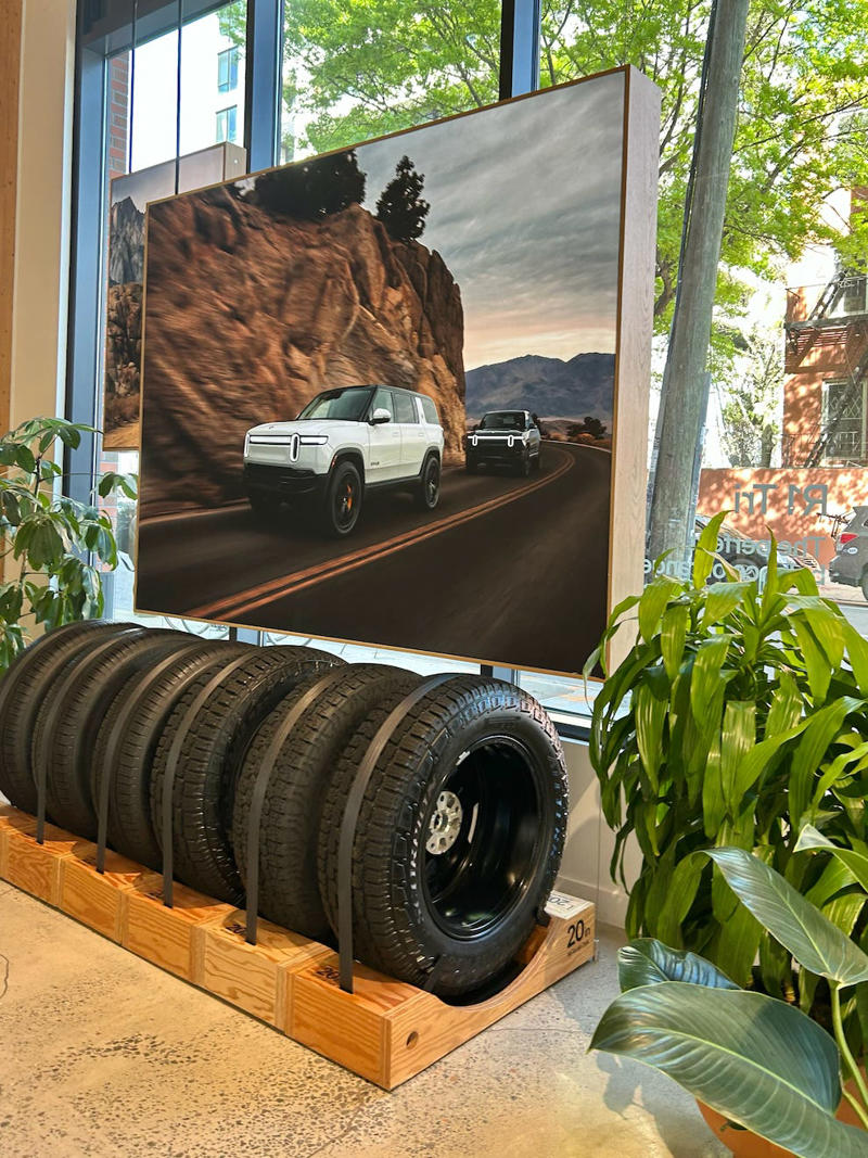 The decor was colorful, outdoorsy, and relaxed. It had two EVs featured in the store., Rivian had Boxed Water in a basket at the door., The decor was colorful, outdoorsy, and relaxed., A Rivian spokesperson told me that the store is designed for families., The store had a merchandise section with locally sourced reusable bags, A Rivian employee took me on a test drive., I didn't see too many customers during my visit., I went to Tesla's showroom in the Meatpacking District the next day., The store's design was tech-forward, sleek, and futuristic., Tesla had some interactive elements in the space., The wall posters were more show than tell., The space also showed off Tesla's tech., Tesla's Optimus humanoid robot was on display., The staff seemed used to tourists popping in and taking photos., I was offered an espresso while I waited for my test ride., To sum it up: I enjoyed both experiences.