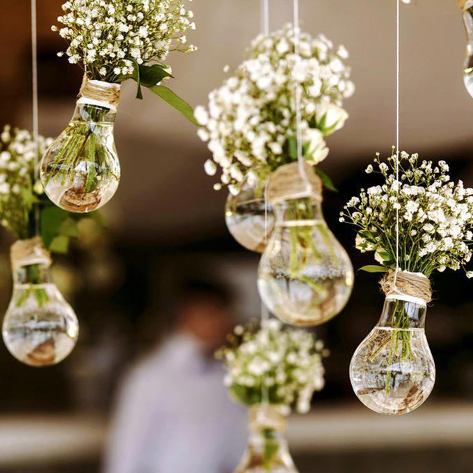 A Photo Journey of Your Story, Ample Outdoor Reception Lighting, Hang Chandeliers From Trees, Birdseed Confetti, DIY Photo Booth, Make Your Own Seating, Pallet Dance Floor, Succulent Wedding Gifts, DIY Wooden Wedding Arch, Tree Stump Centerpieces, Whimsical Light Bulbs Flower Holders, Lawn Games, Wooden Direction Signs, Use What You Have, DIY Wedding Decorations Concrete Numbers or Letters, Accommodate for the Weather, Arbor Seating, Use Your Resources Wisely, Marquee Letters