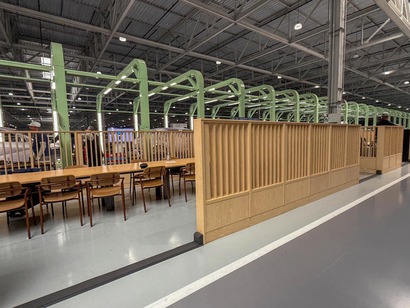 There are employee meeting and break areas located along the inspection and assembly areas. My tour began in the plant's modern main lobby., The Metaplant site consists of 11 buildings totalling 7.5 million square feet of space., Stamped parts are transported by automated guided vehicles, or AGVs., The stamped metal panels are then stored in these massive racks., Here are parts of the Ioniq 9, Hyundai's new flagship three-row EV SUV., The next part of the tour is the welding shop., The vehicles' interiors are then assembled by hand.