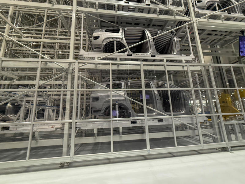 Here are parts of the Ioniq 9, Hyundai's new flagship three-row EV SUV. My tour began in the plant's modern main lobby., The Metaplant site consists of 11 buildings totalling 7.5 million square feet of space., Stamped parts are transported by automated guided vehicles, or AGVs., The stamped metal panels are then stored in these massive racks., Here are parts of the Ioniq 9, Hyundai's new flagship three-row EV SUV., The next part of the tour is the welding shop., The vehicles' interiors are then assembled by hand.