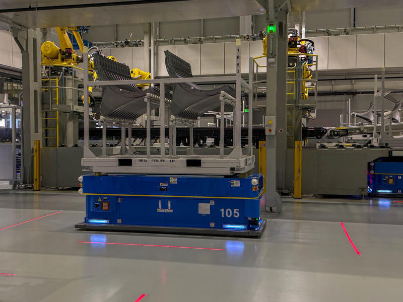 Stamped parts are transported by automated guided vehicles, or AGVs. My tour began in the plant's modern main lobby., The Metaplant site consists of 11 buildings totalling 7.5 million square feet of space., Stamped parts are transported by automated guided vehicles, or AGVs., The stamped metal panels are then stored in these massive racks., Here are parts of the Ioniq 9, Hyundai's new flagship three-row EV SUV., The next part of the tour is the welding shop., The vehicles' interiors are then assembled by hand.