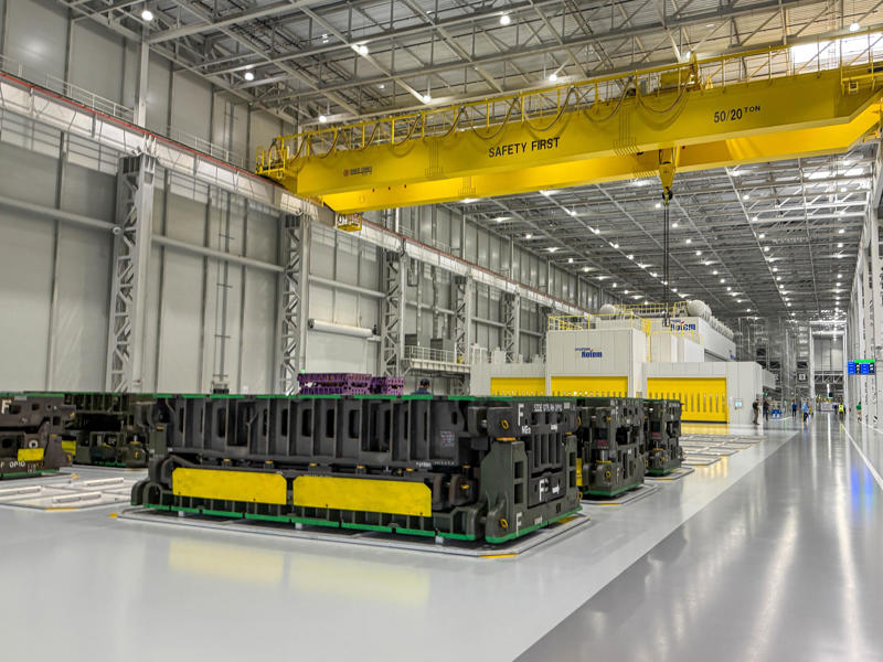 The production process starts in the stamping shop, where sheet metal is cut and stamped into parts that will make up the frame of the car. My tour began in the plant's modern main lobby., The Metaplant site consists of 11 buildings totalling 7.5 million square feet of space., Stamped parts are transported by automated guided vehicles, or AGVs., The stamped metal panels are then stored in these massive racks., Here are parts of the Ioniq 9, Hyundai's new flagship three-row EV SUV., The next part of the tour is the welding shop., The vehicles' interiors are then assembled by hand.