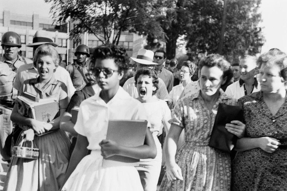 26. Elizabeth Eckford, One of the Nine Black Students Who Integrated Into Little Rock’s Central High School 1. 22-Year-Old Being Dropped Off for Naval Flight Training in South Texas, 2. NASA Scientists With Their Board of Calculations, 3. Queen Elizabeth II Driving Prince Charles and Princess Anne, 4. Kids on a Movie Date, 5. Audrey Hepburn Casually Grocery Shopping With Her Pet Deer, 6. A Mother With Her First 11 Kids — She Went on to Have Six More, 7. The Runner-Up in a Shirley Temple Look-Alike Contest, 8. Macy’s Thanksgiving Day Parade, 9. Sightseers at Niagara Falls, 10. The First African-American Stewardess in the U.S., Ruth Carol Taylor, 11. Open Air School in the Netherlands, 12. The Original TV Remote, 13. Mingling With Bears at Yellowstone, 14. Roadside Meals While Traveling, 15. Listening to Music at a Record Store, 16. Getting Cooled Air Piped Into the Car While Eating at a Drive-in Restaurant, 17. Selfie: 1957 Style, 18. Teenage Beatles Members Performing as Wedding Singers, 19. Bride and Groom, 20. Danish Zookeeper Watering the Emperor Penguins, 21. A Couple’s First Christmas Together, 22. Daytona Beach, 23. Joe Pesci at 14 Years Old, 24. Woman in One of Nine Stores She Opened, 25. Family Pool Day, 26. Elizabeth Eckford, One of the Nine Black Students Who Integrated Into Little Rock’s Central High School, 27. Oh, You Know, Just a Llama in Times Square, 28. Jayne Mansfield With Miss Hollywood, 29. Illegal Drag Racing in the L.A. River Basin