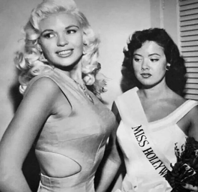 28. Jayne Mansfield With Miss Hollywood 1. 22-Year-Old Being Dropped Off for Naval Flight Training in South Texas, 2. NASA Scientists With Their Board of Calculations, 3. Queen Elizabeth II Driving Prince Charles and Princess Anne, 4. Kids on a Movie Date, 5. Audrey Hepburn Casually Grocery Shopping With Her Pet Deer, 6. A Mother With Her First 11 Kids — She Went on to Have Six More, 7. The Runner-Up in a Shirley Temple Look-Alike Contest, 8. Macy’s Thanksgiving Day Parade, 9. Sightseers at Niagara Falls, 10. The First African-American Stewardess in the U.S., Ruth Carol Taylor, 11. Open Air School in the Netherlands, 12. The Original TV Remote, 13. Mingling With Bears at Yellowstone, 14. Roadside Meals While Traveling, 15. Listening to Music at a Record Store, 16. Getting Cooled Air Piped Into the Car While Eating at a Drive-in Restaurant, 17. Selfie: 1957 Style, 18. Teenage Beatles Members Performing as Wedding Singers, 19. Bride and Groom, 20. Danish Zookeeper Watering the Emperor Penguins, 21. A Couple’s First Christmas Together, 22. Daytona Beach, 23. Joe Pesci at 14 Years Old, 24. Woman in One of Nine Stores She Opened, 25. Family Pool Day, 26. Elizabeth Eckford, One of the Nine Black Students Who Integrated Into Little Rock’s Central High School, 27. Oh, You Know, Just a Llama in Times Square, 28. Jayne Mansfield With Miss Hollywood, 29. Illegal Drag Racing in the L.A. River Basin
