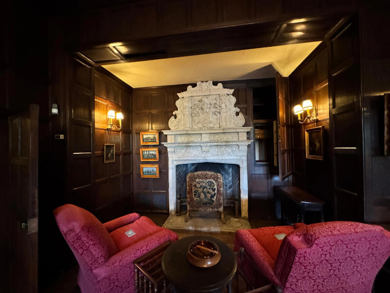 There are personalized touches all over the house's limestone exterior., It took three years to complete Coe Hall., One of the first rooms you can view is Coe's den., It's covered in dark wood, giving a masculine atmosphere., The art in the living room is original to the home., It's certainly not a bad place to spend your weekends., The craftsmanship throughout the house was impossible to miss., There was another portrait of Coe hanging in the corner., The main staircase felt straight out of a castle., And no, that's not wallpaper. This design was hand-painted onto the wall., The windows gave her a view of the gardens she painstakingly designed., This is her bathroom. Once again, it's very French., Now it was time to check out the much-revered grounds., Right off the bat, this fountain caught my eye., Can't you just hear someone saying, "Once upon a time…"?, Rogers entertained her friends in the Tea House on nice days., It looks like the inside of a Tiffany's box., Walking through it felt like walking through a storybook., One corner of the building was anchored by this giant palm tree., It has the largest collection of camellias under glass in the northeast., However, camellia season is in January, so we missed it.